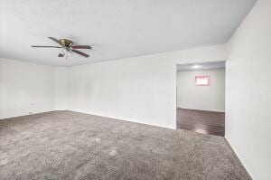 carpeted empty room featuring ceiling fan