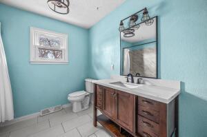 bathroom featuring tile patterned flooring, vanity, and toilet