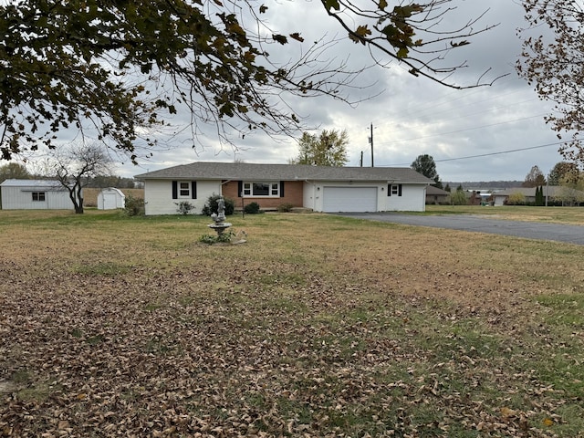 9800 Red Spring Rd, Mountain Grove, MO 65711 - ranch-style home featuring asphalt driveway, an attached garage, a front yard, and a storage shed