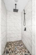 bathroom with a tile shower