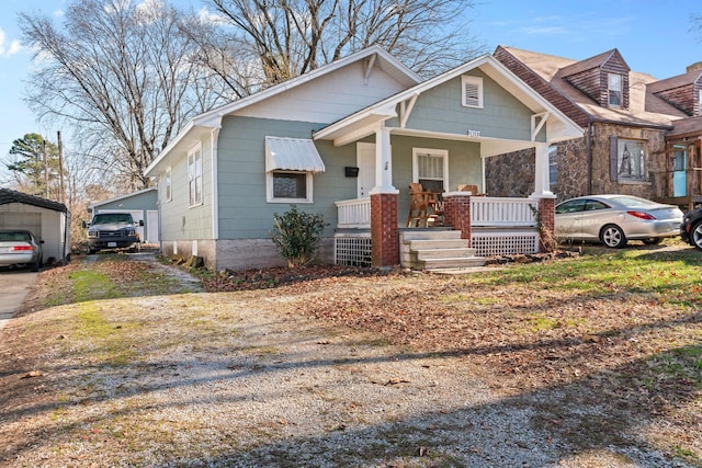 view of front of house featuring covered porch and a carport