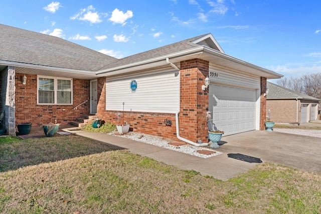 ranch-style house featuring a garage and a front lawn