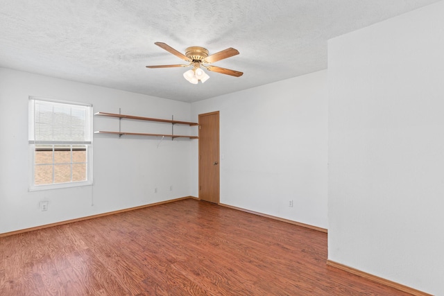 spare room featuring ceiling fan, wood-type flooring, and a textured ceiling