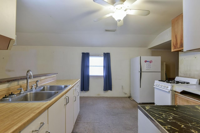 kitchen with white appliances, light colored carpet, vaulted ceiling, sink, and white cabinets