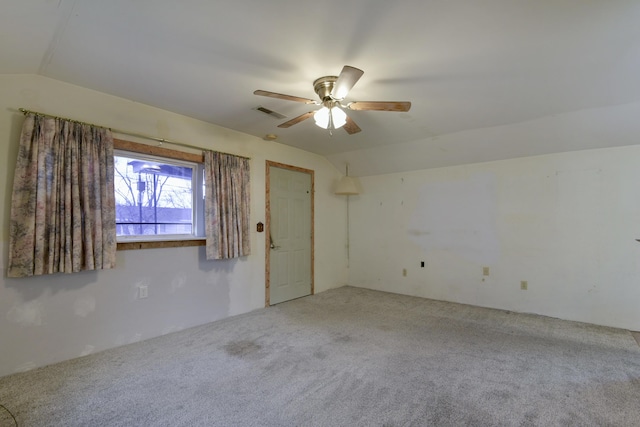 unfurnished room featuring carpet, ceiling fan, and lofted ceiling