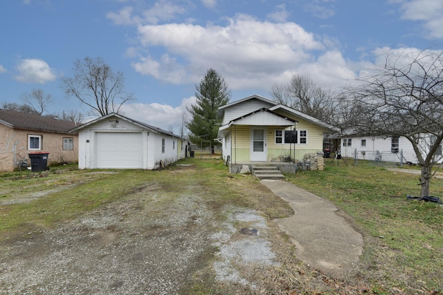 view of front facade featuring a porch, a garage, an outdoor structure, and a front lawn