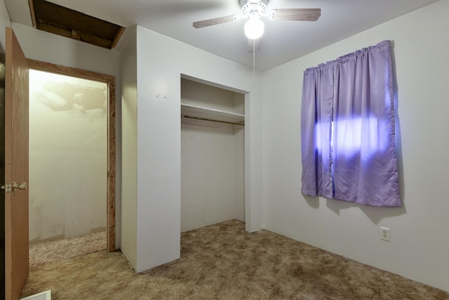 unfurnished bedroom with light carpet, a closet, and ceiling fan