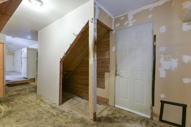 interior space with carpet floors and vaulted ceiling