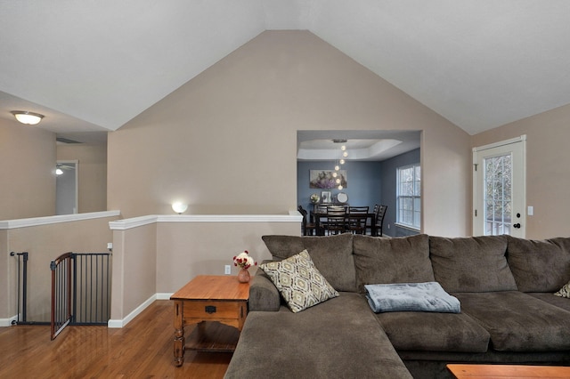 living room featuring wood-type flooring and high vaulted ceiling