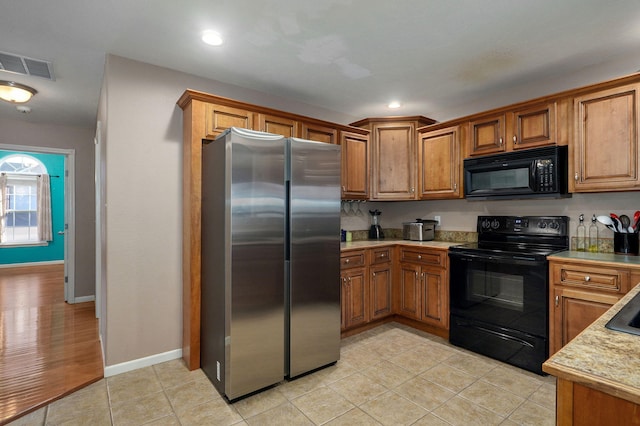 kitchen featuring black appliances and light hardwood / wood-style floors