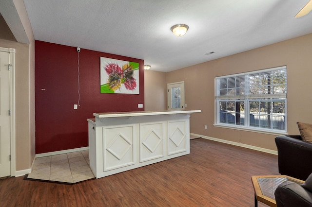 interior space with wood-type flooring and a textured ceiling