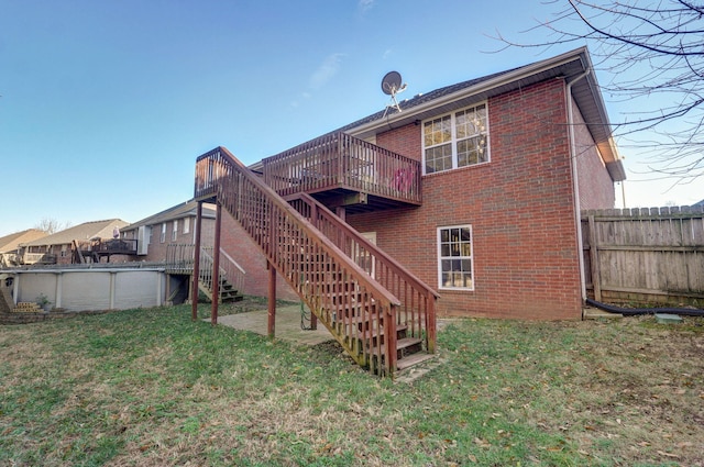 back of house with a lawn and a swimming pool side deck