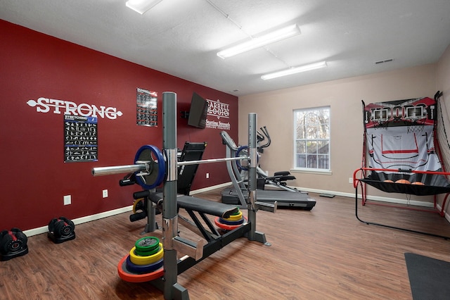 workout room with a textured ceiling and hardwood / wood-style flooring