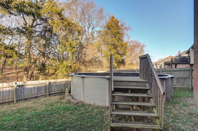 view of yard with a swimming pool side deck