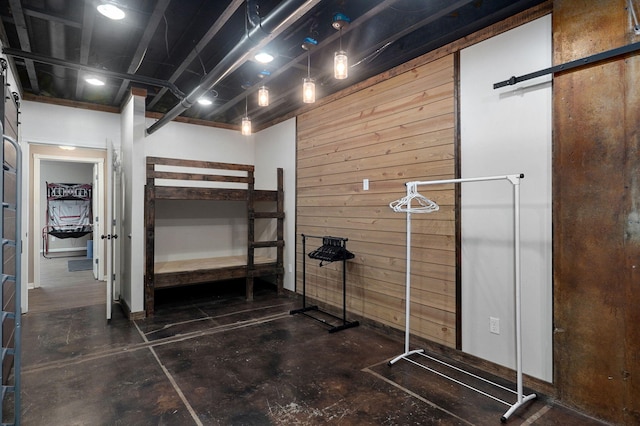 unfurnished bedroom featuring wood walls