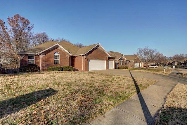 ranch-style home featuring a front yard and a garage