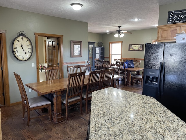 dining area featuring a textured ceiling, ceiling fan, and dark wood-type flooring