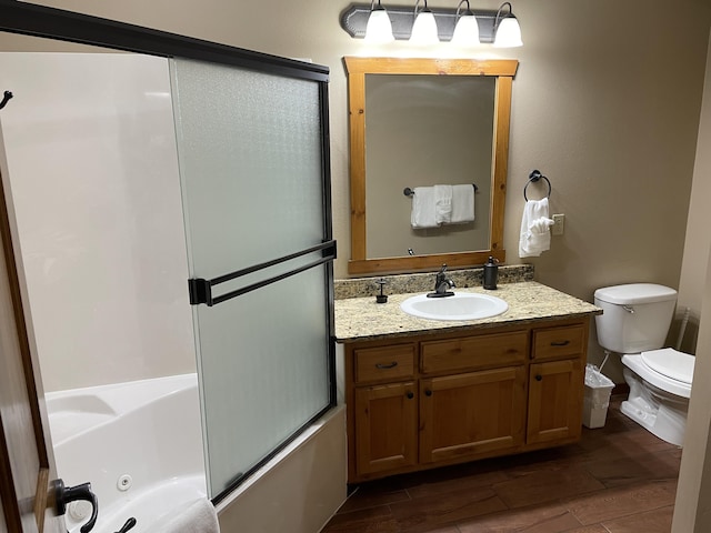 full bathroom with toilet, vanity, enclosed tub / shower combo, and hardwood / wood-style flooring