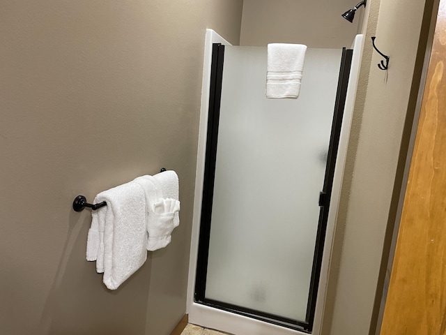 bathroom featuring a shower with door