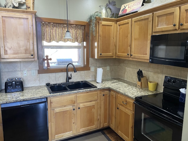 kitchen featuring light stone countertops, sink, backsplash, and black appliances