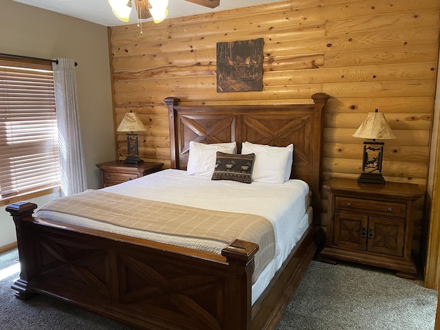 bedroom with dark carpet, rustic walls, and ceiling fan