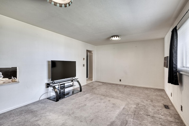 carpeted living room with a textured ceiling