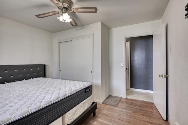 bedroom with a closet, ceiling fan, and hardwood / wood-style floors