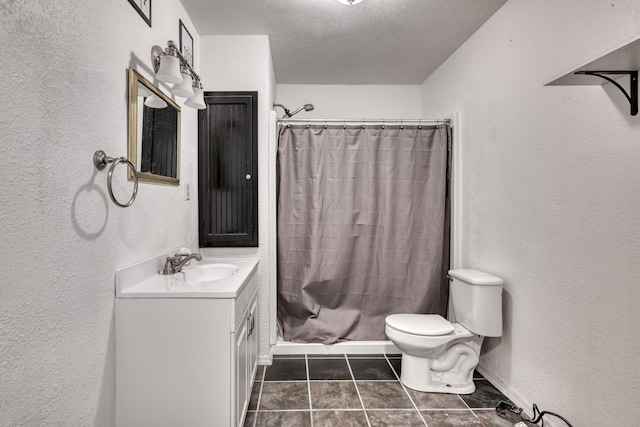 bathroom featuring tile patterned floors, a shower with curtain, vanity, a textured ceiling, and toilet