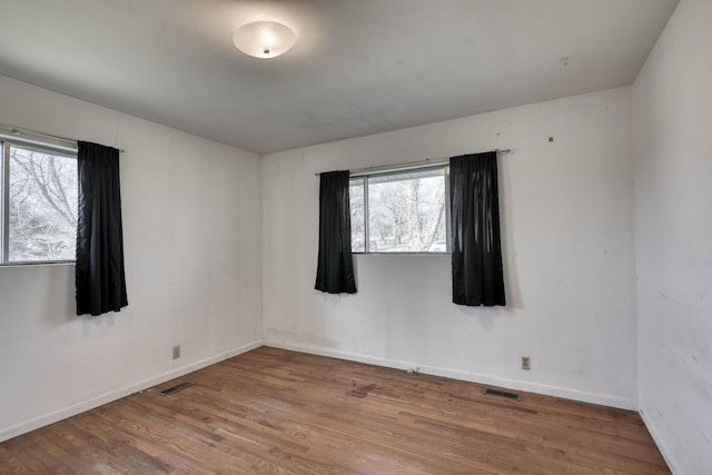 spare room with wood-type flooring