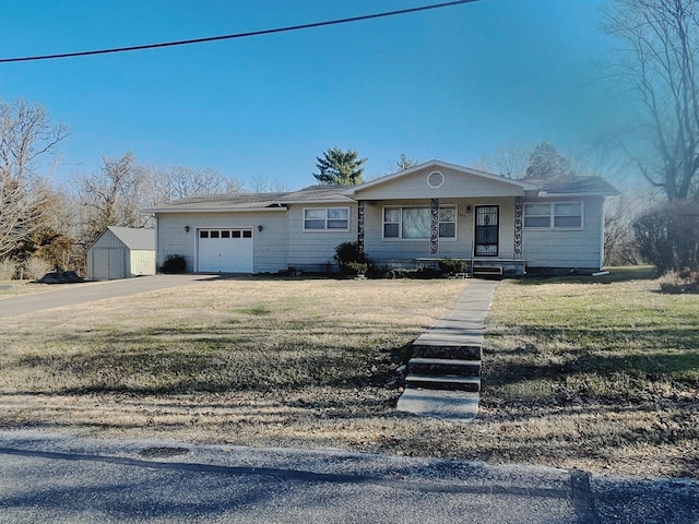 single story home with covered porch, an outbuilding, and a front yard