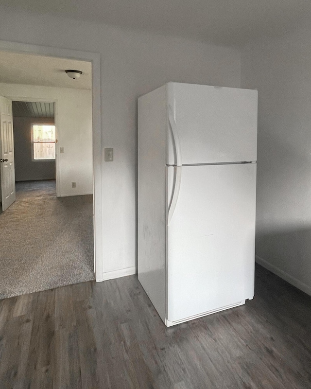 kitchen featuring dark hardwood / wood-style flooring and white fridge