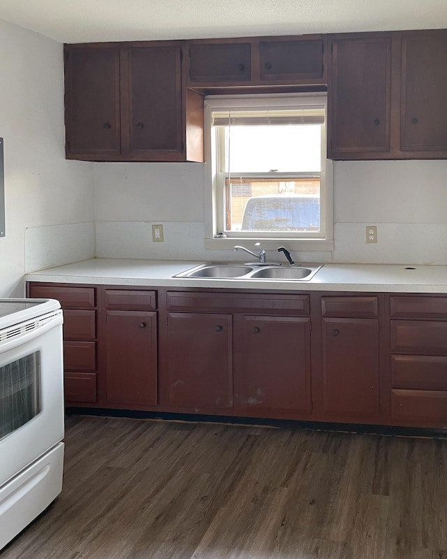 kitchen featuring white range with electric stovetop, sink, and dark wood-type flooring