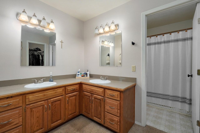 bathroom featuring vanity and curtained shower