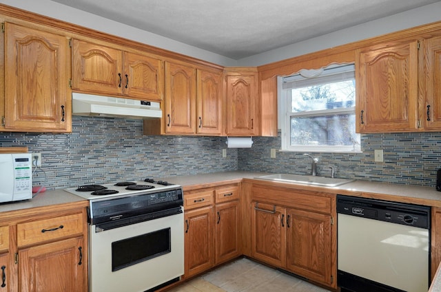 kitchen with decorative backsplash, sink, light tile patterned floors, and white appliances