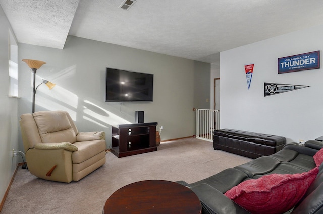 carpeted living room with a textured ceiling