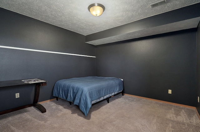 bedroom featuring carpet flooring and a textured ceiling