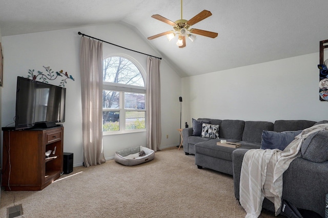 carpeted living room with a textured ceiling, ceiling fan, plenty of natural light, and vaulted ceiling