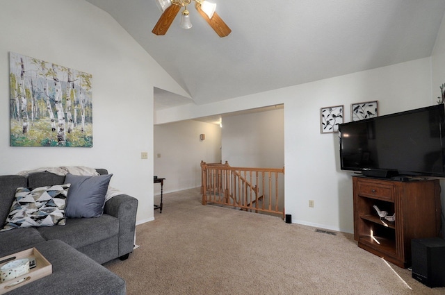 living room featuring light colored carpet, vaulted ceiling, and ceiling fan