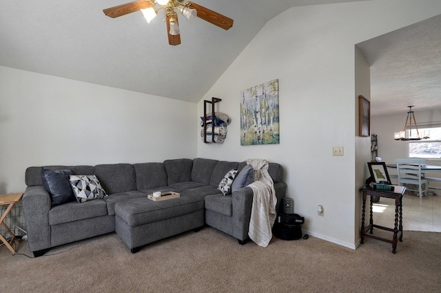 living room featuring carpet floors, vaulted ceiling, and ceiling fan