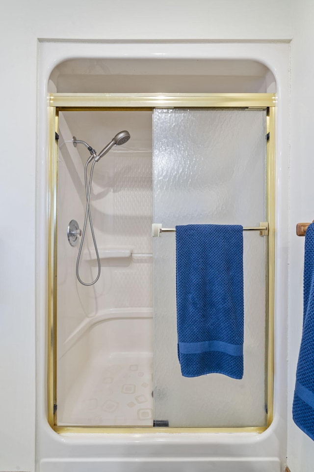 bathroom featuring a shower with door