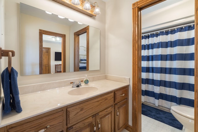 bathroom featuring radiator, vanity, and toilet