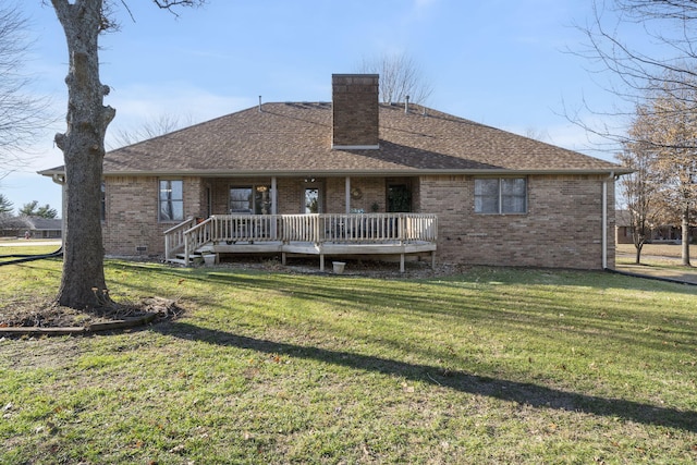 rear view of house featuring a deck and a lawn