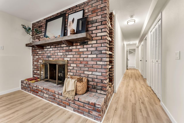 corridor featuring baseboards and wood finished floors