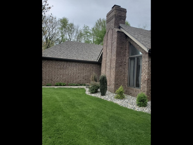 view of side of home featuring a yard