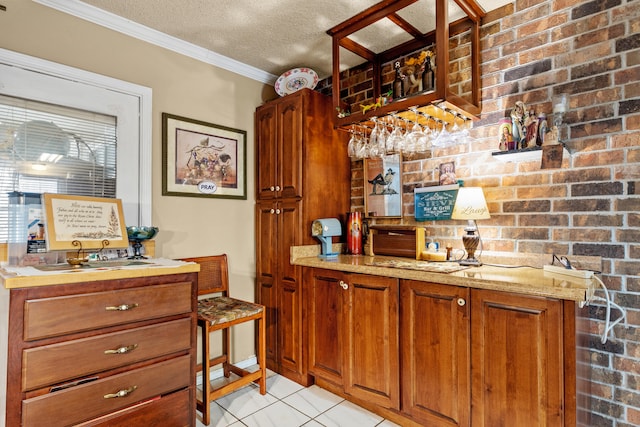 bar with crown molding, brick wall, a textured ceiling, and light tile patterned flooring