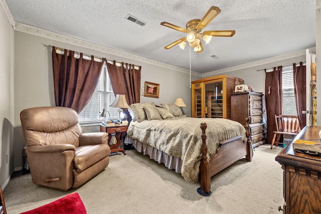 carpeted bedroom featuring ceiling fan and a textured ceiling