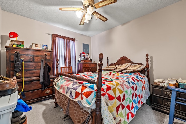 bedroom featuring ceiling fan, light colored carpet, and a textured ceiling