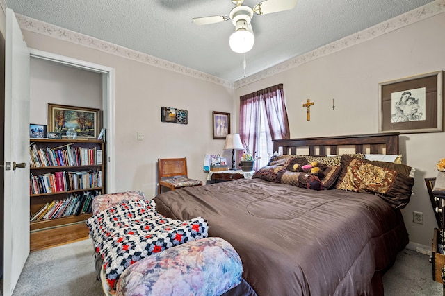 bedroom featuring ceiling fan and a textured ceiling