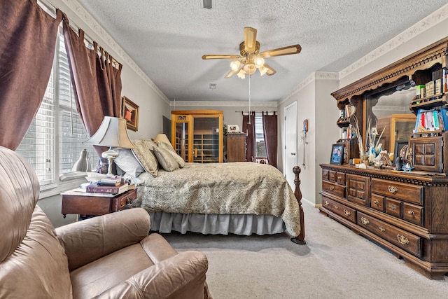 bedroom with crown molding, ceiling fan, carpet flooring, and a textured ceiling