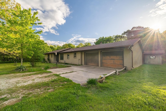 ranch-style home featuring concrete driveway, an attached garage, and a front yard